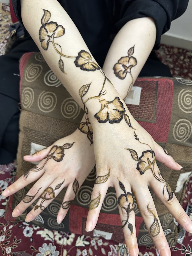 Detailed floral henna across two arms